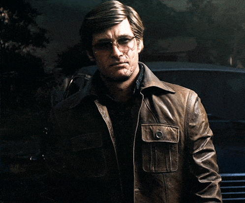 a man wearing glasses and a brown leather jacket
