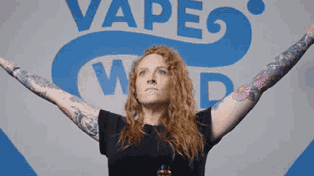 a woman stands in front of a vape world sign