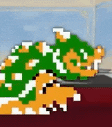 a pixel art drawing of a turtle laying on a bed .