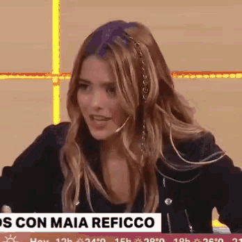 a woman with a microphone in her hair is on a news channel