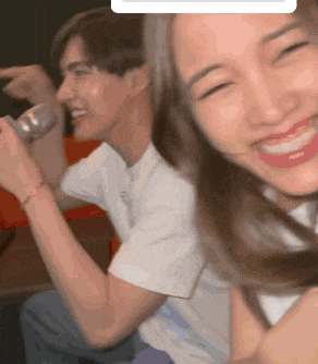 a man and a woman are sitting next to each other and the woman is smiling