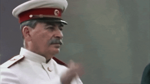 a man in a military uniform salutes with his hand on his forehead