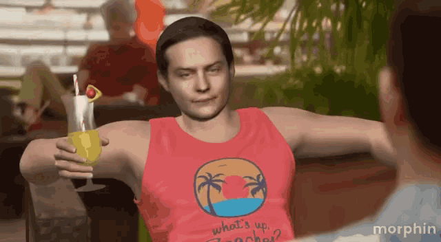 a man wearing a red tank top that says what 's up beaches