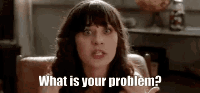 a woman is sitting at a table and asking what is your problem .