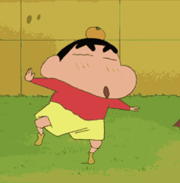 a cartoon character in a red shirt and yellow shorts is standing in the grass