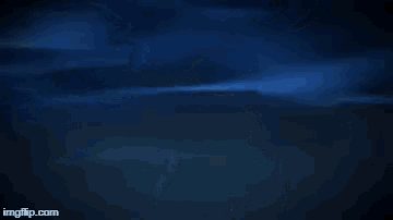 a superhero is flying through the air in the dark with a light coming out of his chest .
