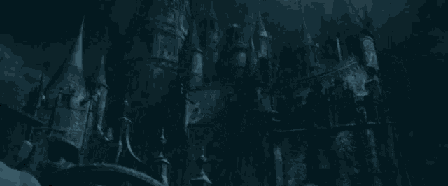 a castle with a lot of towers in the dark
