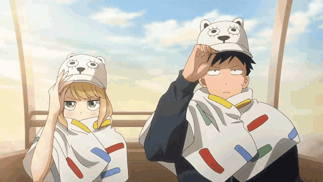 a man and a woman are wearing bear hats and blankets