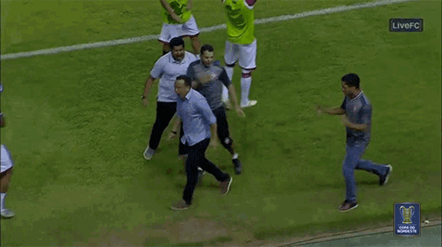 a group of people on a soccer field with the words live fc on the bottom