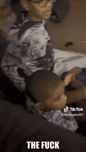 a tiktok video of two young boys with the words the fuck written on the bottom
