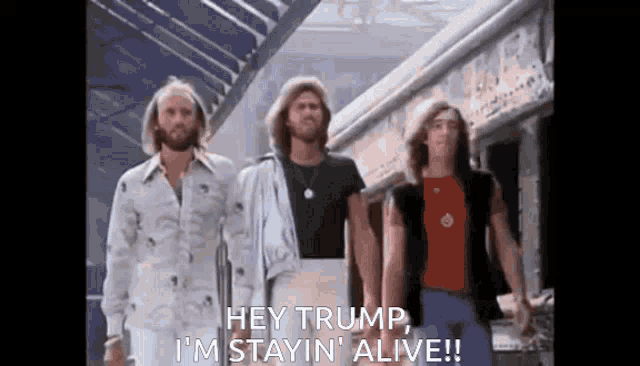 three men are standing next to each other and one of them is saying hey trump , i 'm stayin ' alive !