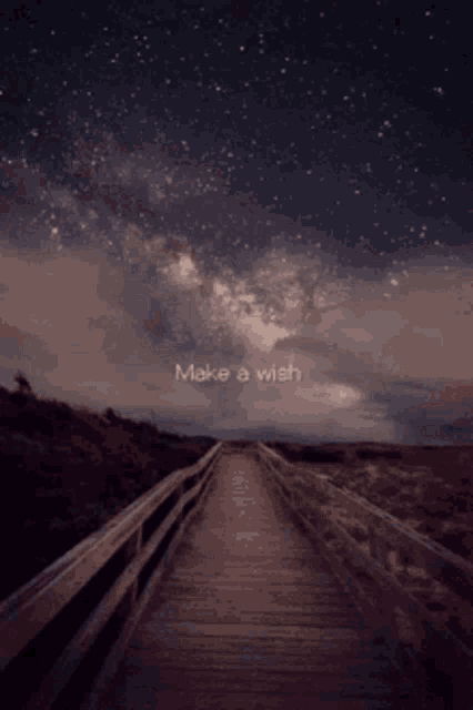 a wooden bridge with the words make a wish written in the sky