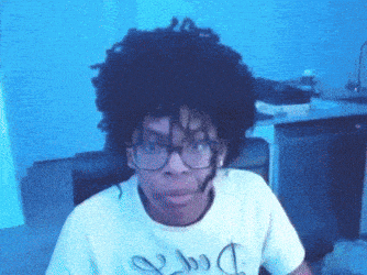a man wearing glasses and a t-shirt with a dollar sign on the front