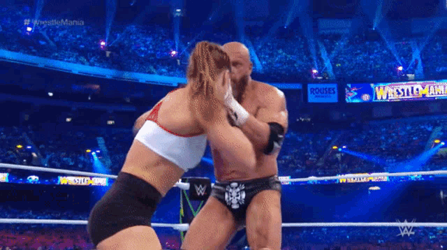 a wrestlemania match is being shown on a television