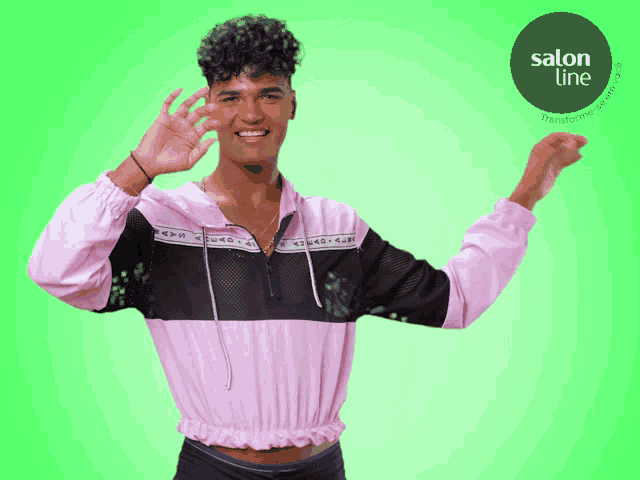a man wearing a pink and black jacket with salon line written on the bottom right