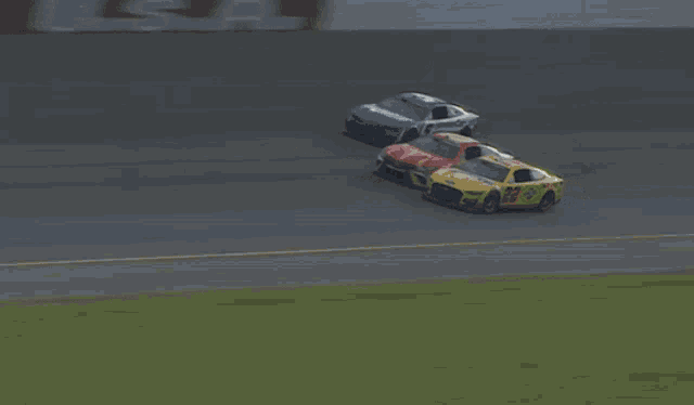 a blurred image of cars racing on a track with a sign that says coca cola