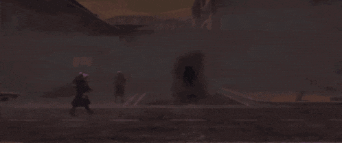 a silhouette of a person walking down a street in the fog