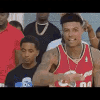 a man in a red miami jersey is standing in a crowd