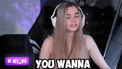 a woman wearing headphones is sitting in a chair and saying you wanna