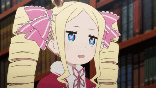 a girl with blonde hair and a pink bow on her hair