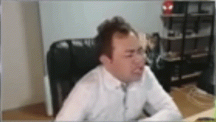 a man in a white shirt and tie is sitting at a table
