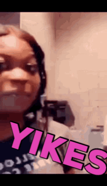 a woman is wearing headphones and the word yikes is on her face