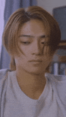 a close up of a young man 's face with chinese writing on it