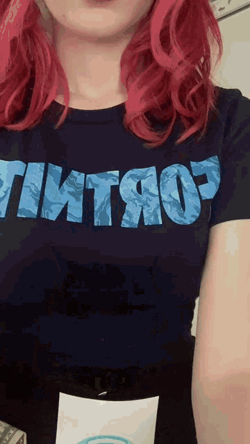 a woman with red hair is wearing a t-shirt that says " tmtjop "