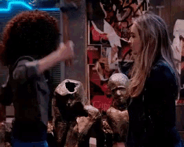 two women are fighting over a statue and one is holding a hammer