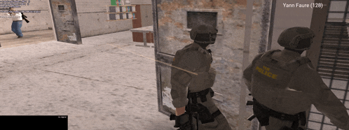 two police officers are standing in a room with yann faure ( 1:28 ) written on the bottom
