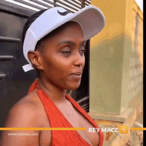 a woman wearing a red top and a white hat with the website www.reymacc.com in the lower right corner