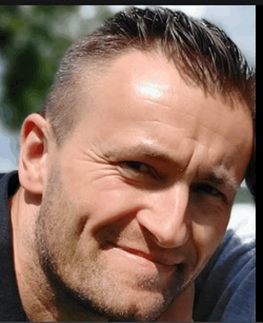 a close up of a man 's face with a beard