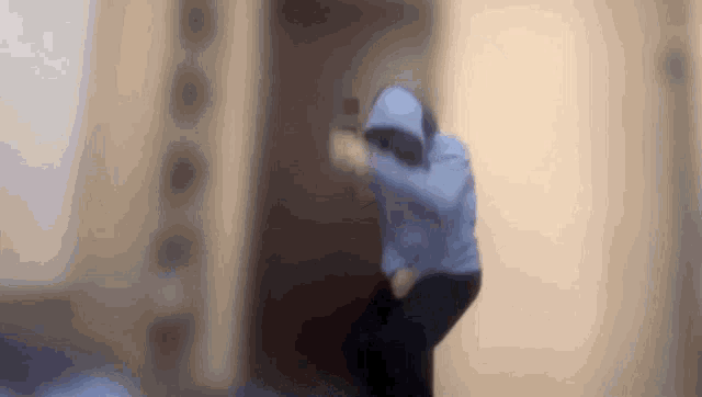 a blurry picture of a person in a blue hoodie