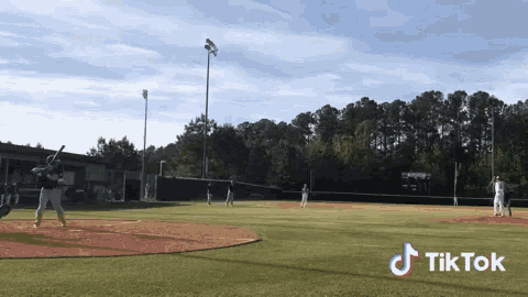 a baseball game is being played on a field with a tiktok logo
