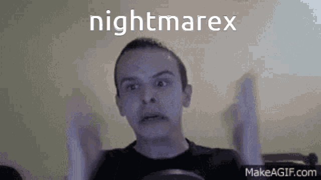 a man is making a funny face in front of a screen that says nightmarex on it .