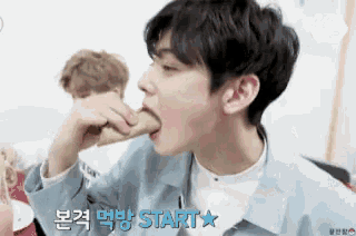 a young man is eating a cone with the words start written on the bottom