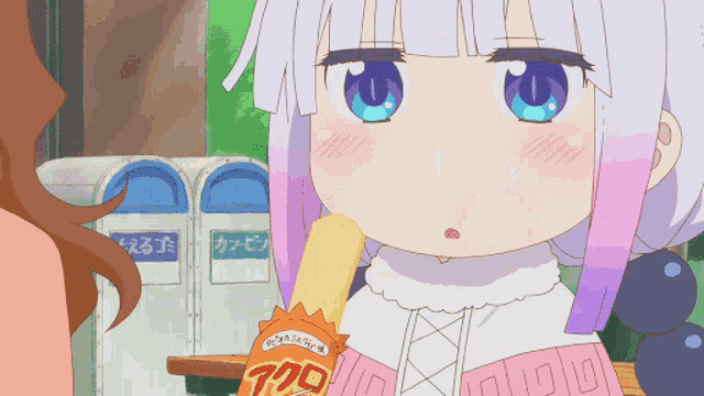 a girl with purple hair is holding a piece of food that says acro on it