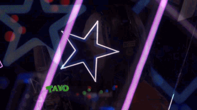 a woman wearing headphones singing into a microphone with a star in the background that says mayo on it