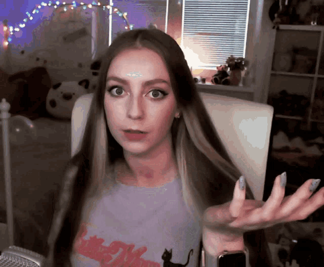 a woman wearing a purple shirt that says little moon