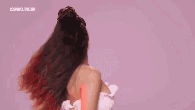 the back of a woman 's head with her hair in a bun .
