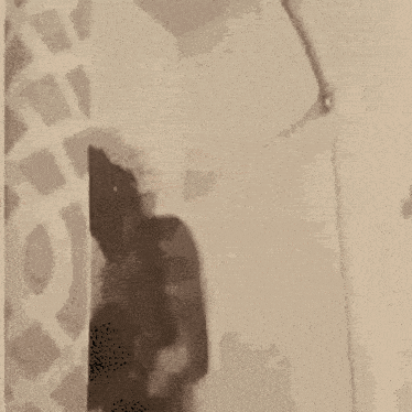 a shirtless man is standing in a shower with a towel around his head .