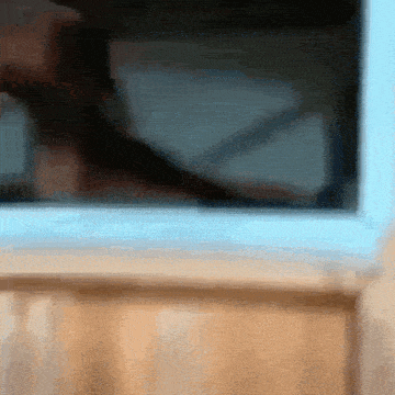 a blurry picture of a person 's face behind a glass door