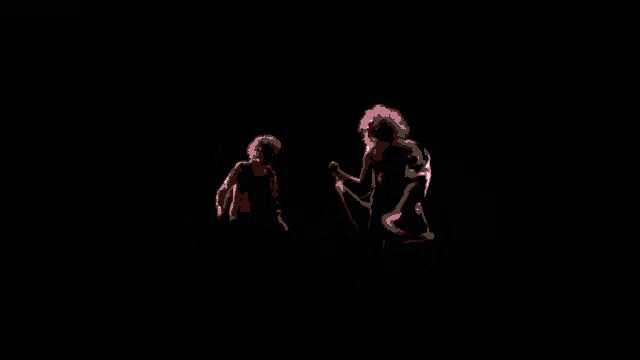 two people are standing next to each other in a pink room .