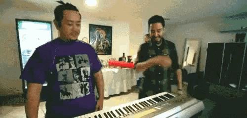 a man wearing a purple shirt that says jesus on it