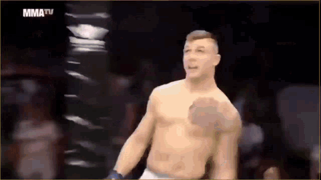 a man without a shirt is in a boxing ring with mma tv written on the bottom