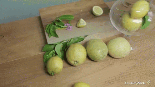 a bunch of lemons on a table with the name anneorshine on the bottom right