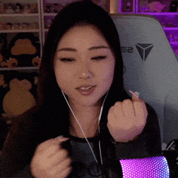 a woman wearing headphones is sitting in a chair with the number 2 on it