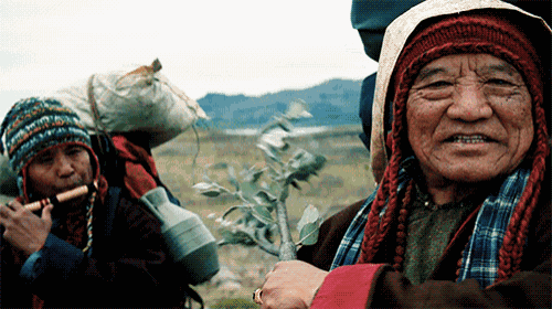 a man playing a flute and another man carrying a bag