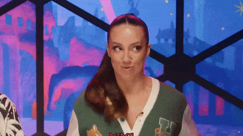 a woman wearing a green and white sweater with the letter r on it