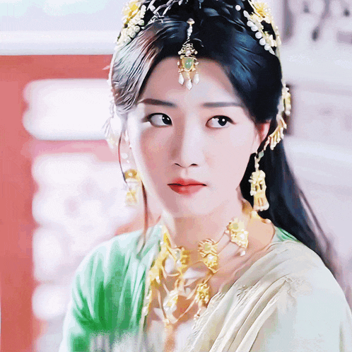 a close up of a woman 's face wearing a crown and earrings